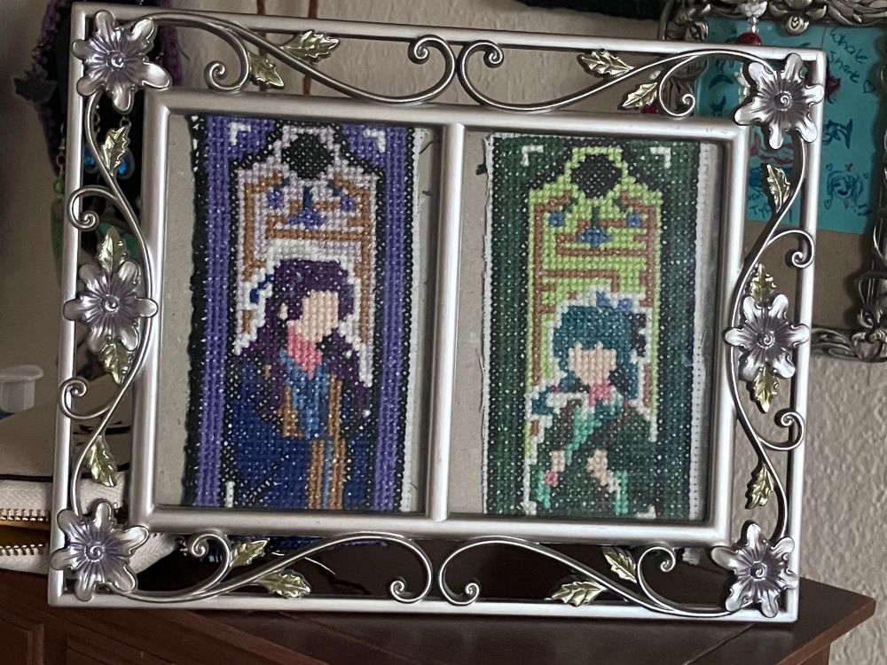 A dual picture frame with cross stitched MaoMao and Jinshi from Apothecary Diaries