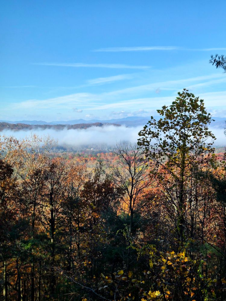 The sun and blue skies return as the low hanging clouds begin to rise and scatter.
