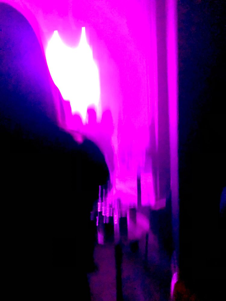 magenta toned blurry photo of a stage