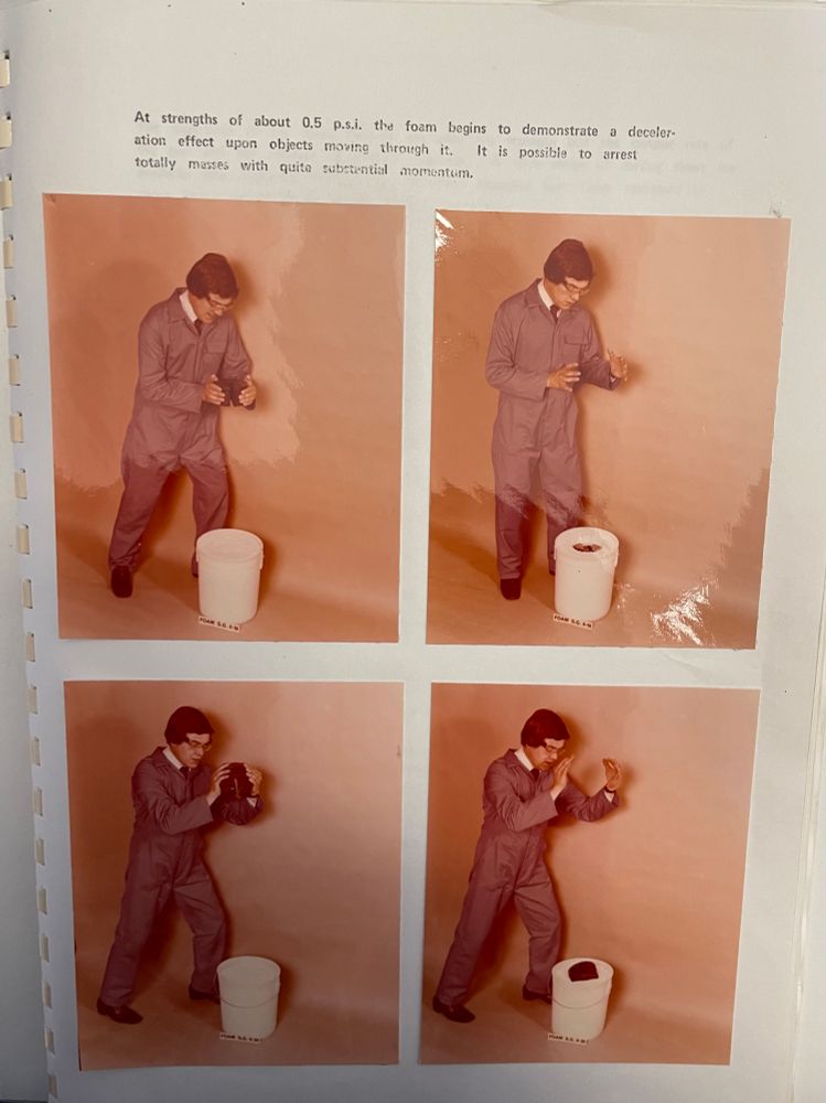 Man in boiler suit and 70s hair theatrically drops weight into bucket of foam. Images have colour shifted with age 