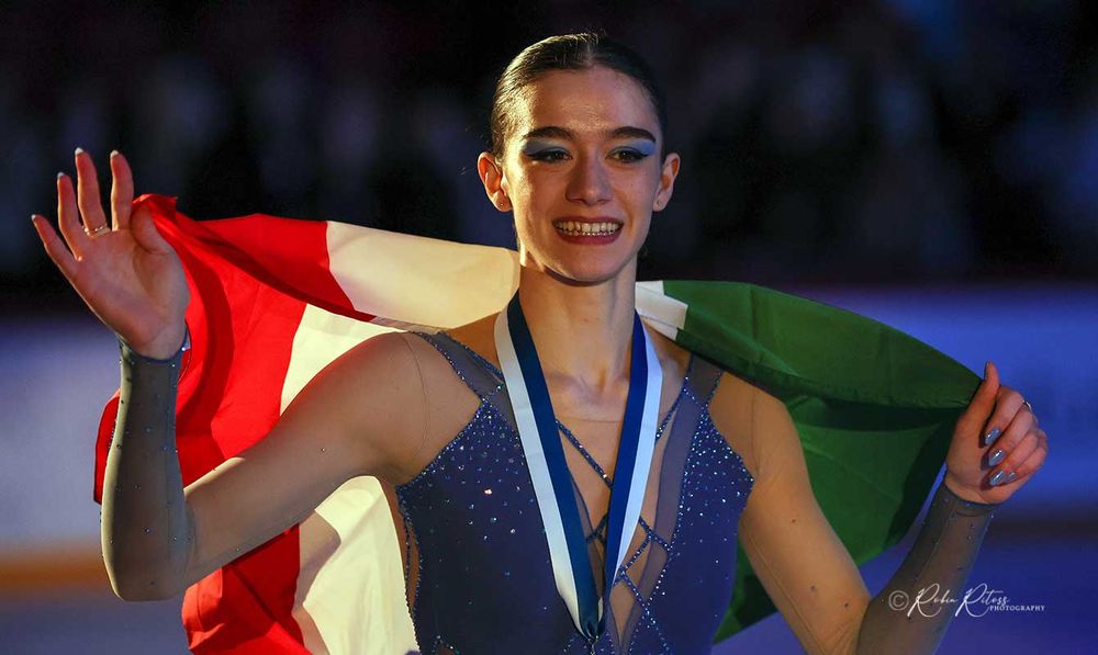 Figure skater Lara Naki Gutmann carrying an Italian flag