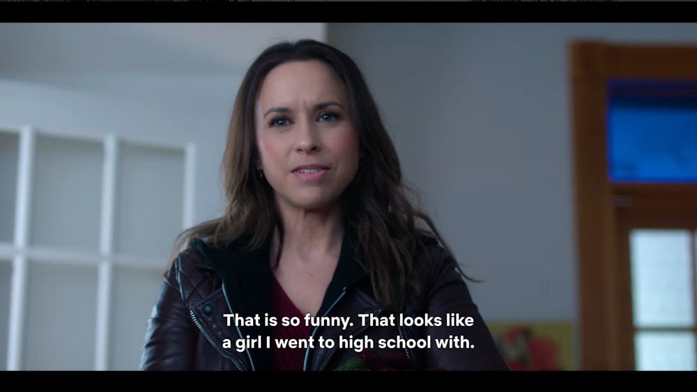 Lacey Chabert looks forward, frowning in confusion. Subtitle reads, "That is so funny. That looks like a girl I went to high school with.'