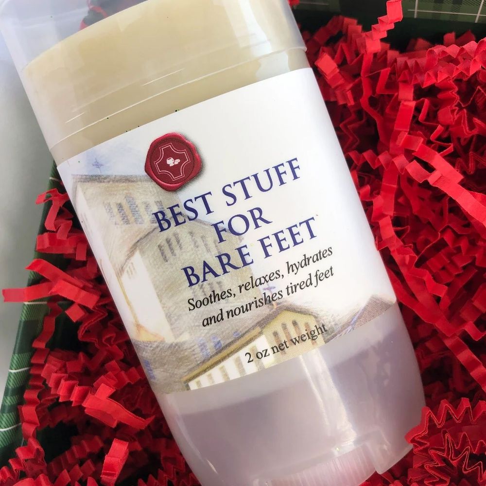 [PIC] A container of Best Stuff for Bare Feet foot salve nestled on a bed of bright red shredded gift paper