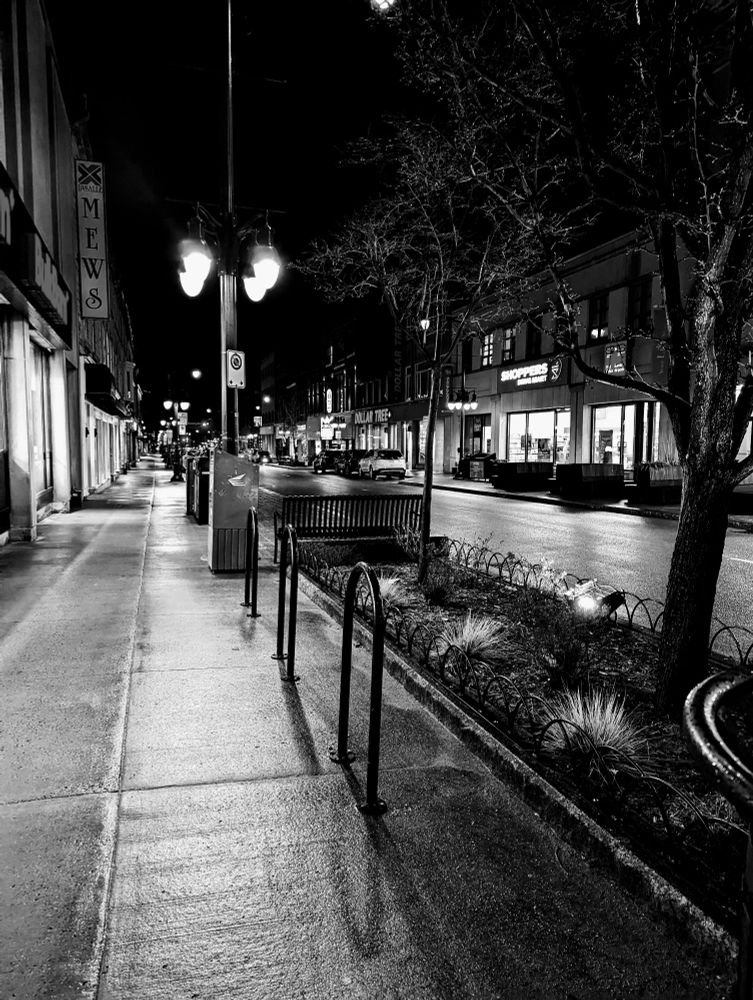 Black and white shot of a wet sidewalk 