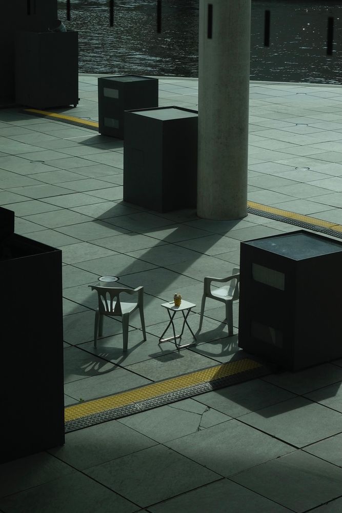 Two chairs in front of the Bundestag close to the Spree river. 