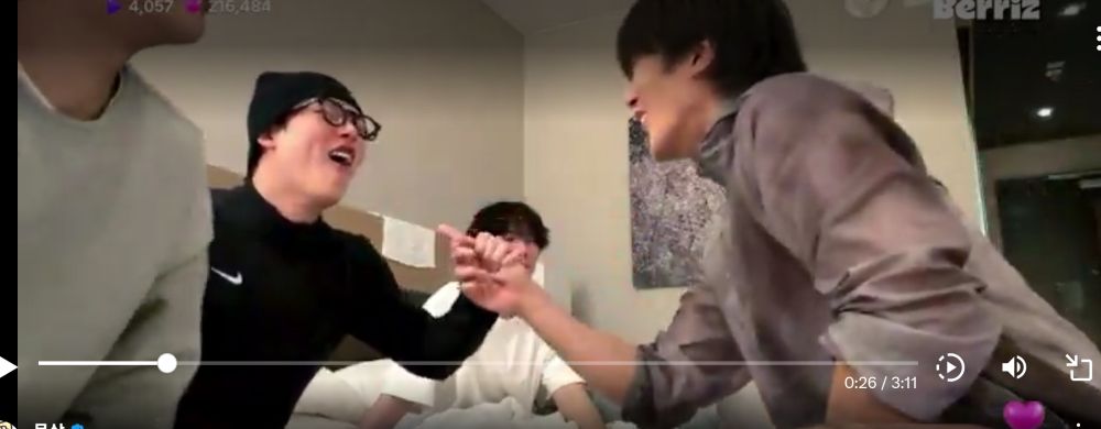 screenshot of monsta x berriz live in dc 12/17/25.  jooheon grabbing minhyuk's hand