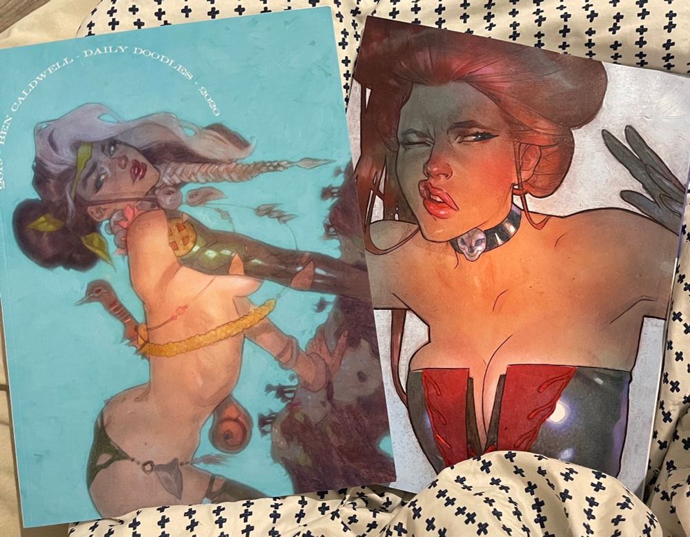 Two volumes of Ben Caldwell’s Daily Doodles, one cover featuring Savage Land Rogue, and the other featuring Hellfire Club Jean Grey