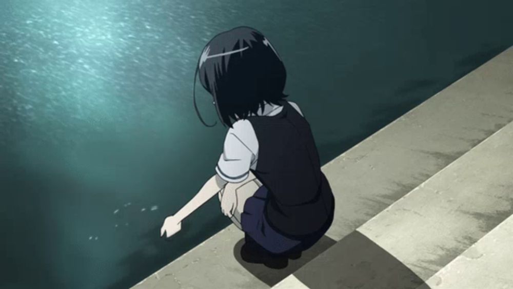 a girl in a school uniform is kneeling on a ledge looking at the water