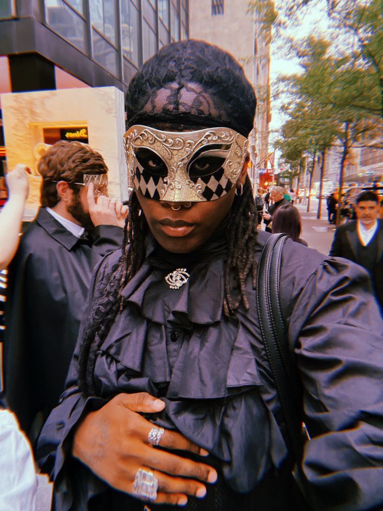 Me in a ruffled blouse and mask in line for the phantom of the opera (immersive experience)