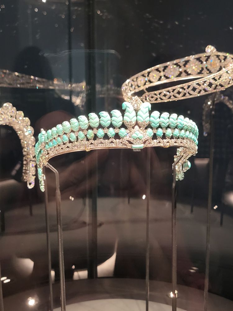 A turquoise and diamond tiara. The turquoise is carved in pointed shapes in 2 rows with a diamond bandeau setting in zigzags. and the wings are lower than a traditional western tiara. 