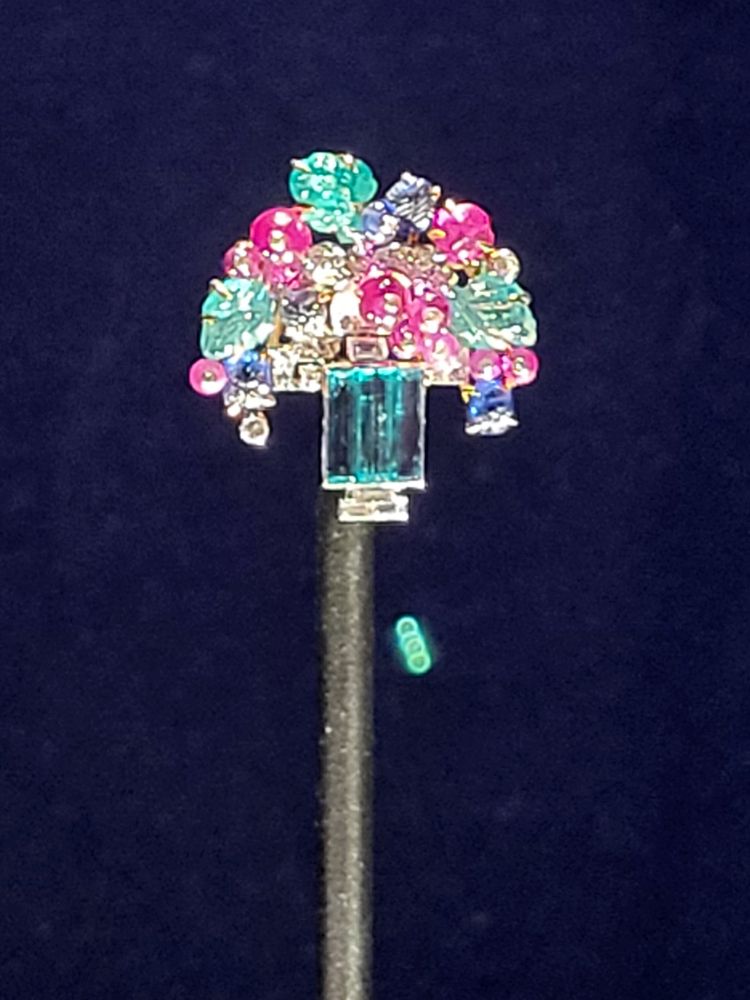 A carved emerald, sapphire, ruby floral brooch for Queen Mary. An early tutti frutti example?
