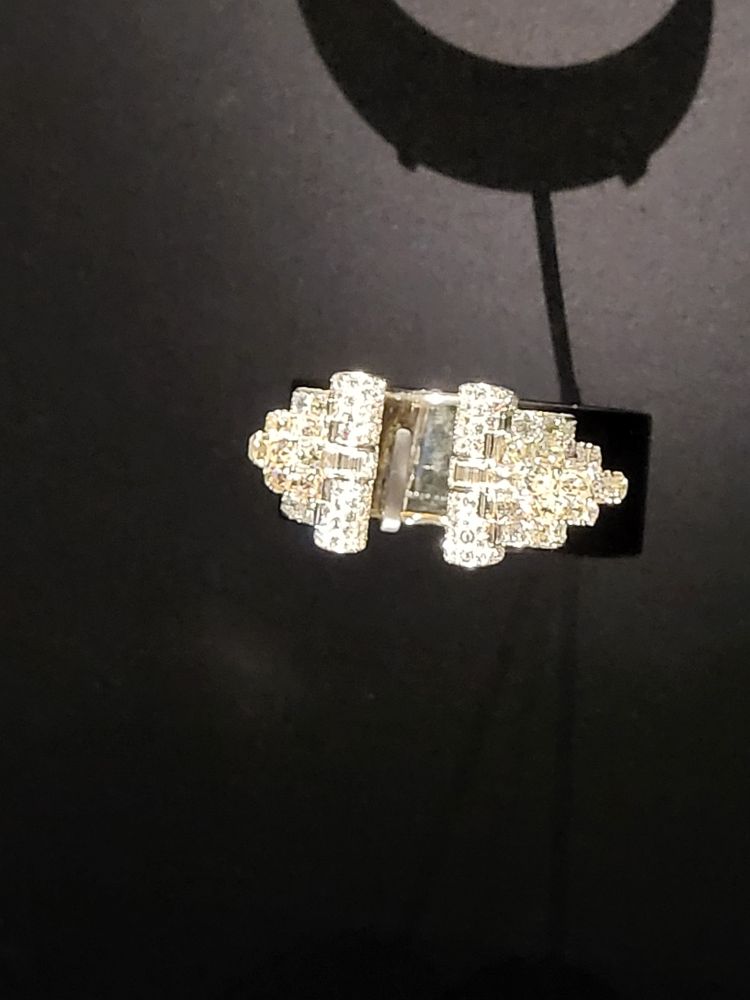 A brooch in the art deco style of a dress clip. 