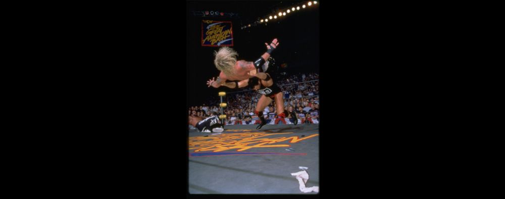 Scott Hall throwing Diamond Dallas Page with the Outsider's Edge. Randy Savage is down near the corner in the back. Based on the trade dress, this looks like the main event match from WCW Great American Bash 1997, which was "The Macho Man" Randy Savage vs. Diamond Dallas Page in a "Falls Count Anywhere" match, and Scott Hall interfered in the match on behalf of Savage.