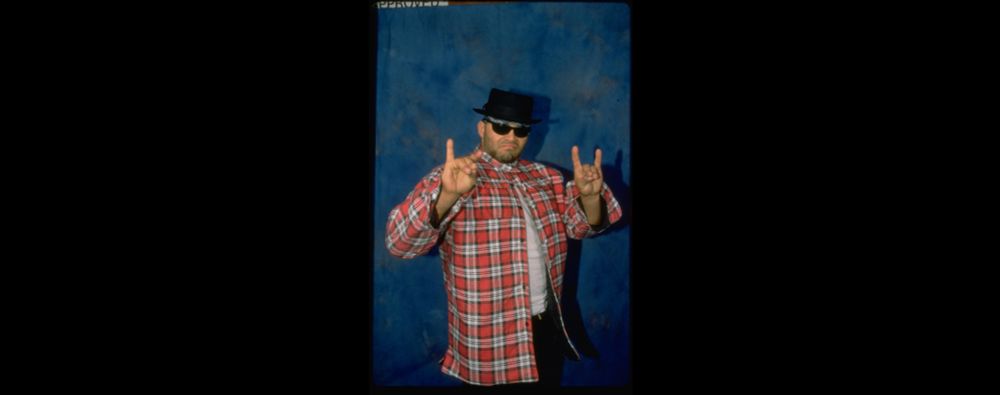 Konnan doing the "Wolfpack/Too Sweet" taunt in front of a blue drape background. Shortly after this, he either got on the phone with Dave Meltzer to spread some gossip, or he went out to do a match where he told his opponent to toss his salad and peel his potatos before doing the rolling clothesline and face buster.
