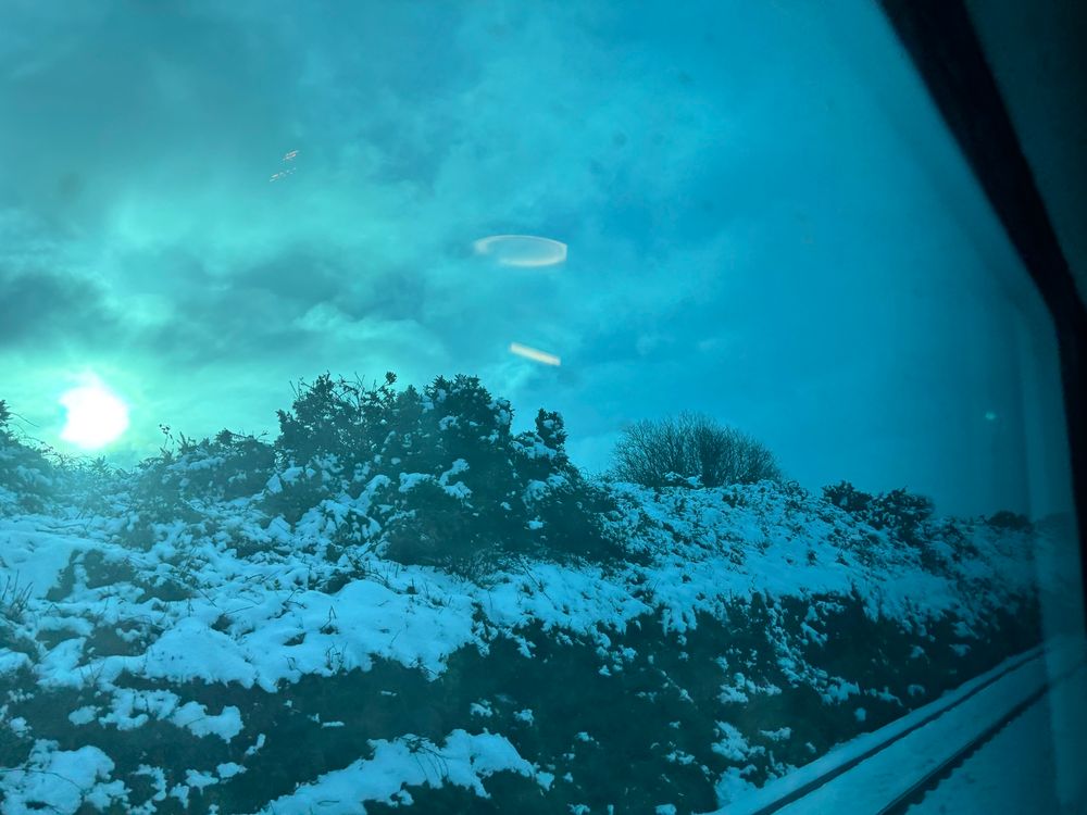 Snow on ground from train window