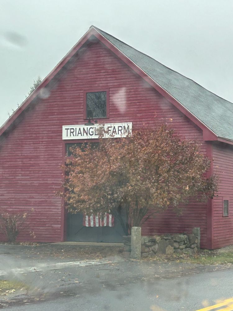 A barn with a sign that says “Triangle Farm”