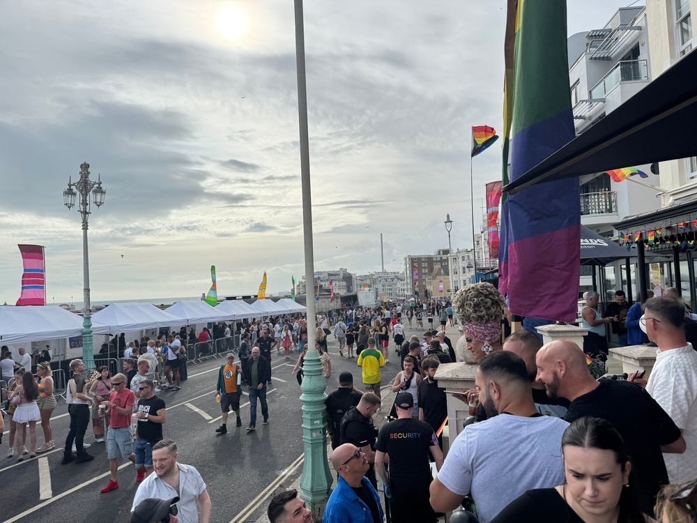 Photo from the balcony of Legends Bar. Lots of people on the balcony and milling around on the front.