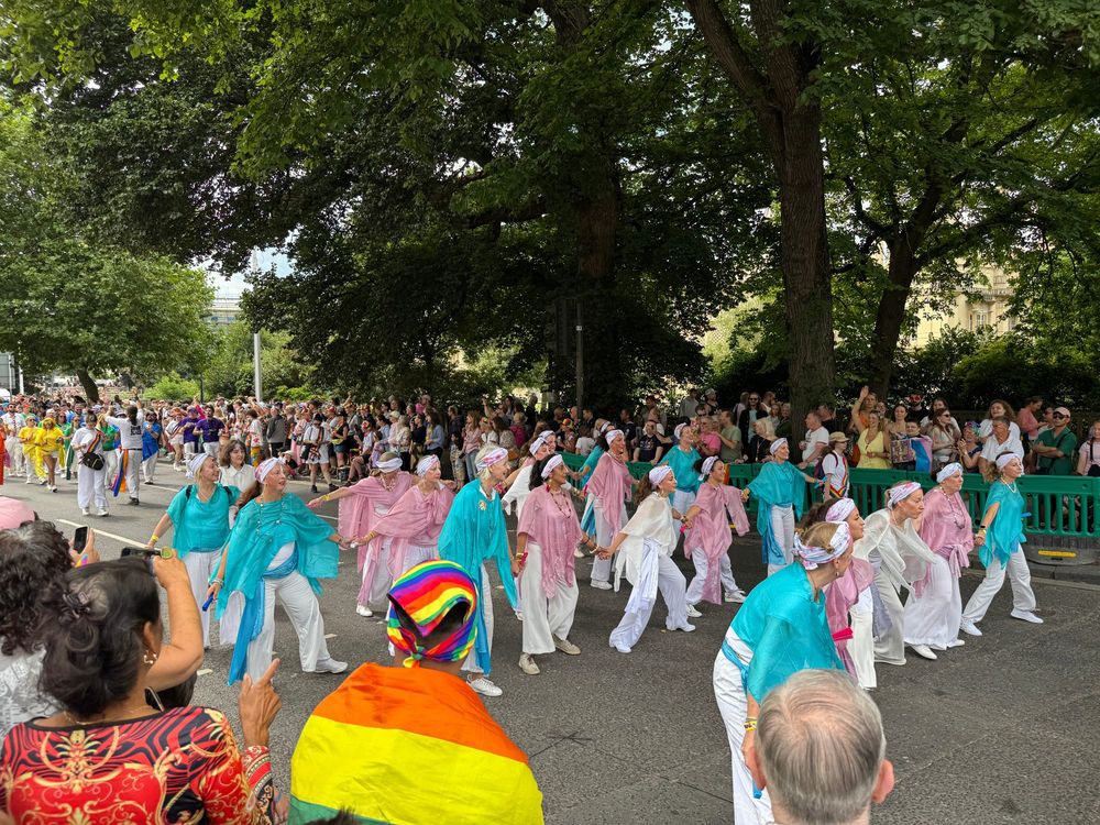 Group of people wearing light blue and pink outfits.