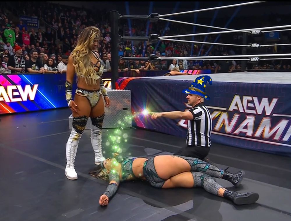 AEW Referee Bryce Remsburg knells beside a knocked out Kris Statlander outside of the ring as Megan Bayne looks over her. Bryce has a wizard hat and has green magic cascading from his finger onto Statlander.