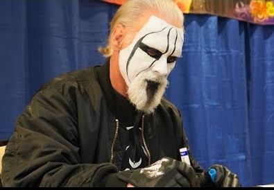 Wrestler Sting in face paint with a white beard with a black streak down the middle.