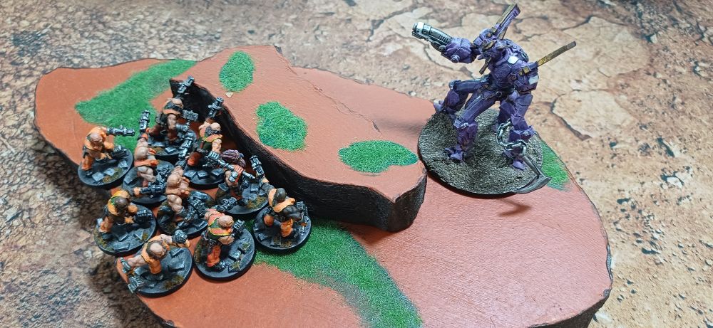 Photo: a space lizard controlled mech towers over space dwarf mechanics cowering behind the peak of a hill