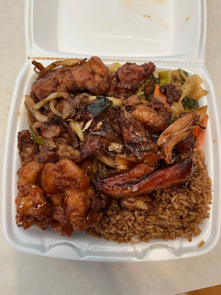 Random Asian food in a styrofoam to go container. 