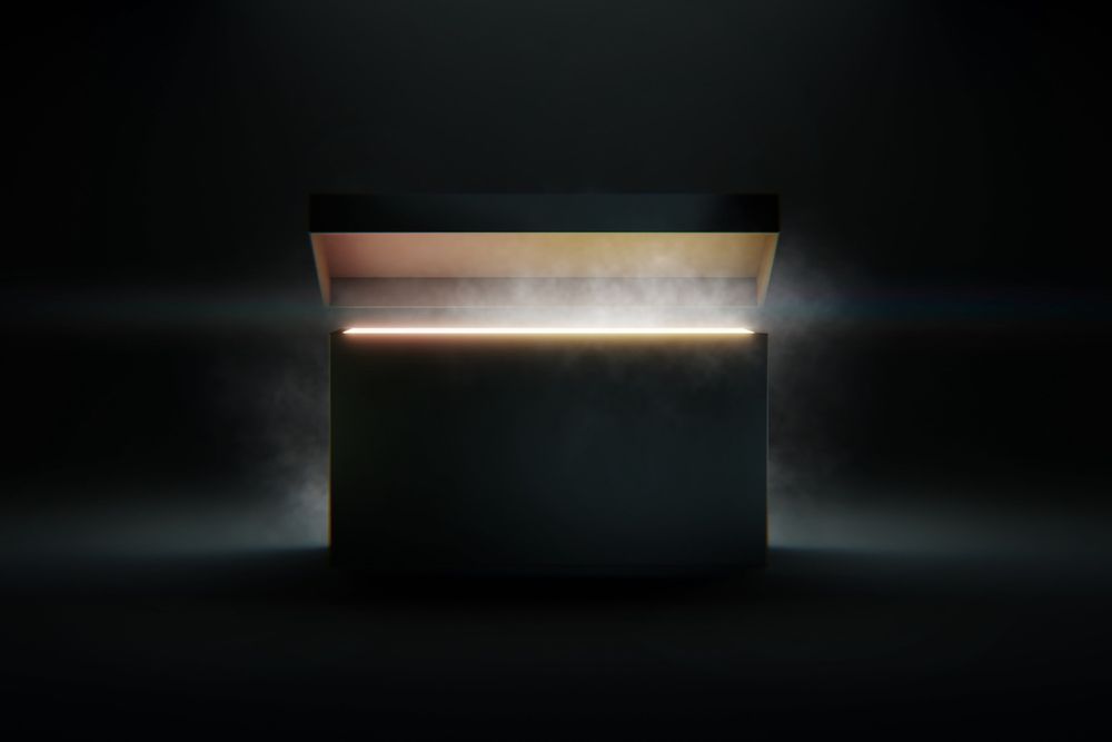 An image of a large, mysterious box opening to reveal light in a dark room.
