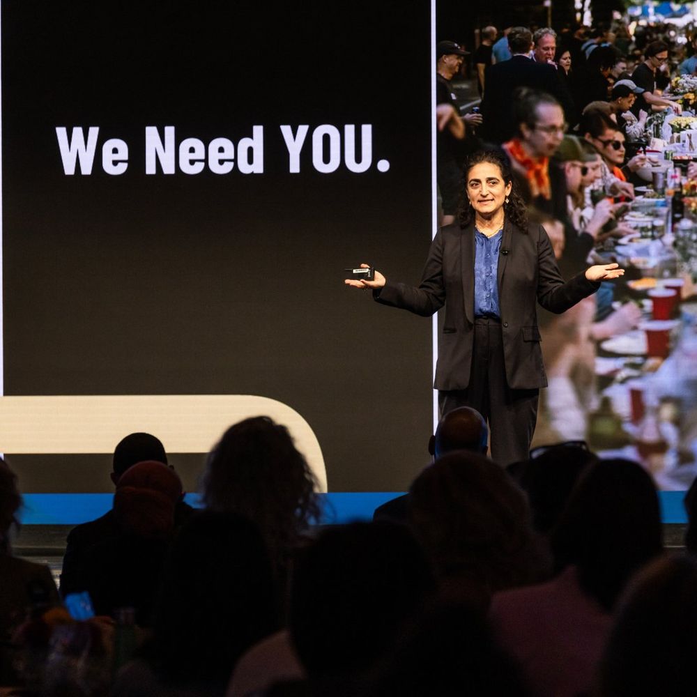A speaker on stage at the Trust in Practice Summit.