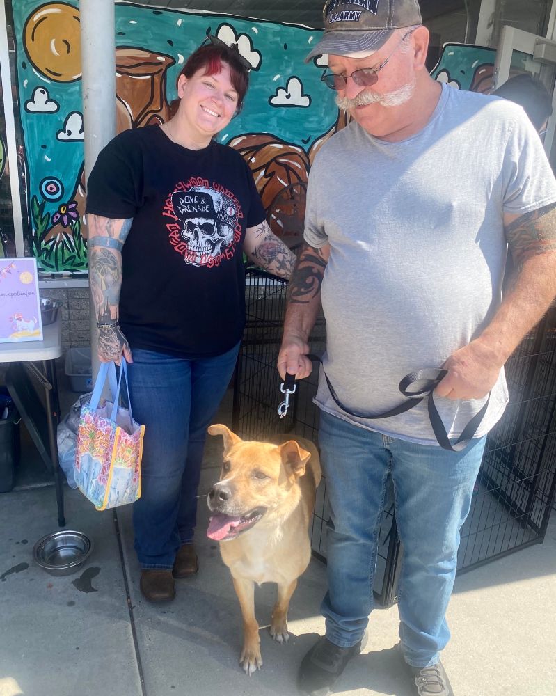 Axel smiles with his new, equally-smiley forever family!