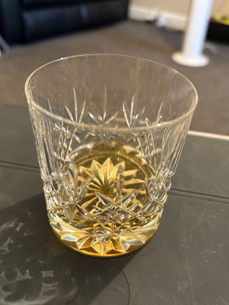 A crystal glass containing whisky.