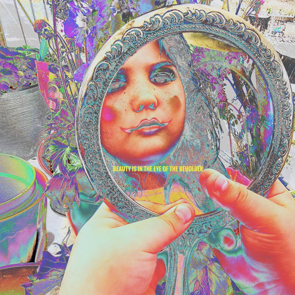 Lil girl, her reflection is in a mirror. She has too much makeup on. The title is beauty is in the eye of the beholder. 