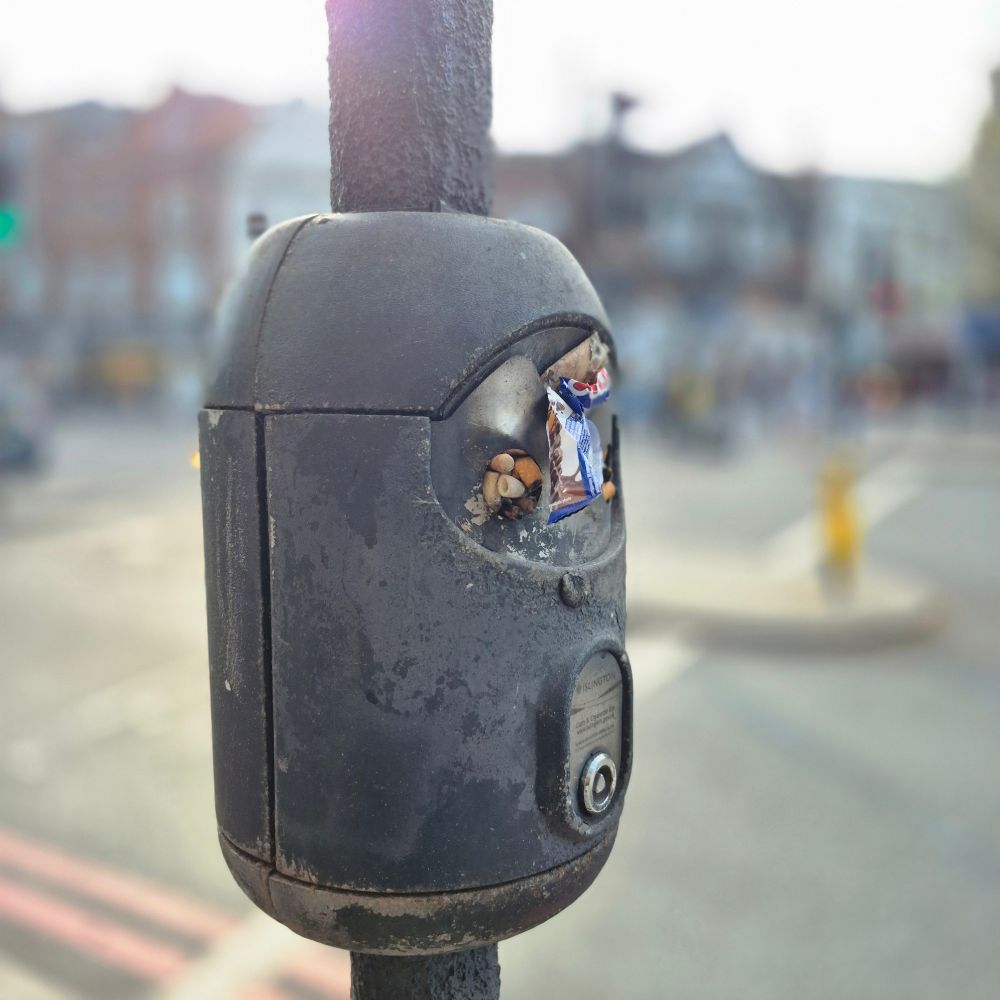 At the pedestrian crossing in Angel, Islington, there is a strange cigarette ashtray attached to the traffic light pole, at face height for people. It is always full of disgusting cigarette butts and ash that fly directly into the faces of pedestrians. It’s really disgusting to see something like this, which you can only find in Islington.