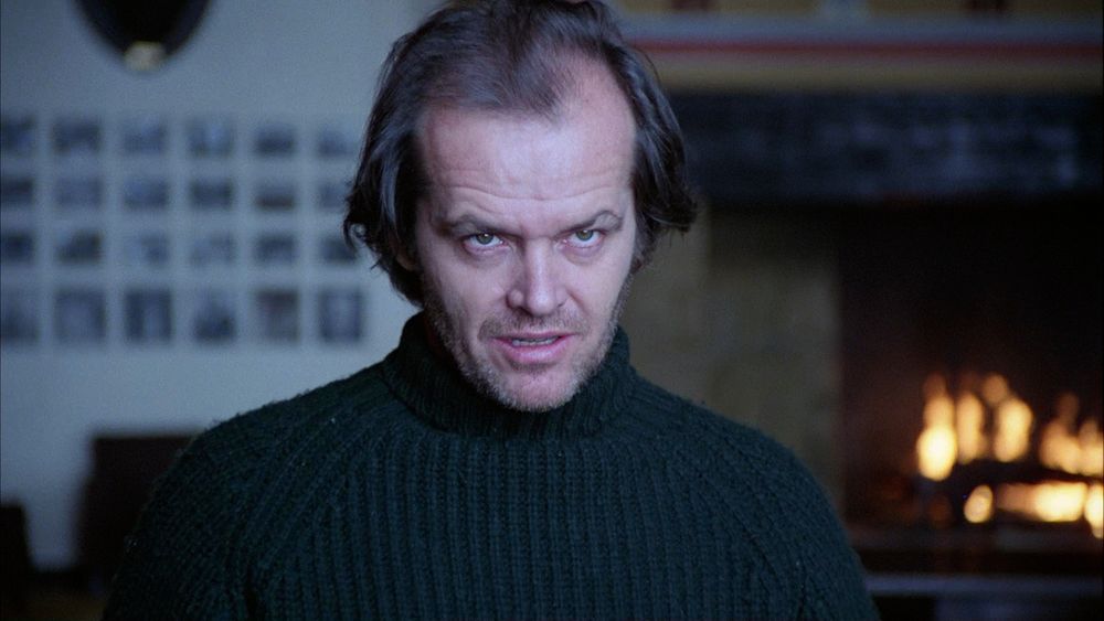 Jack Nicholson from the movie The Shining, staring into the distance with a malicious, deranged expression.