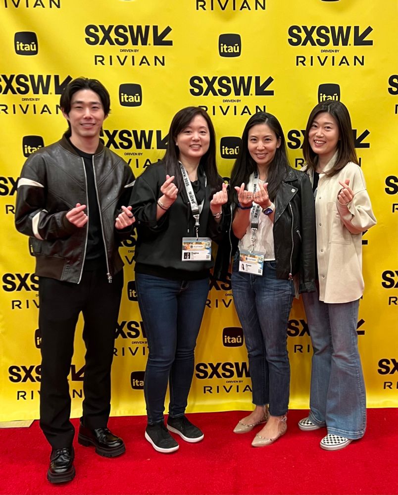 Brian Nam of DIVE Studios, entertainment journalist & Forbes contributor Regina Kim, Karen Paek of Viki, and Jini Cho of WEBTOON posing with finger hearts at SXSW