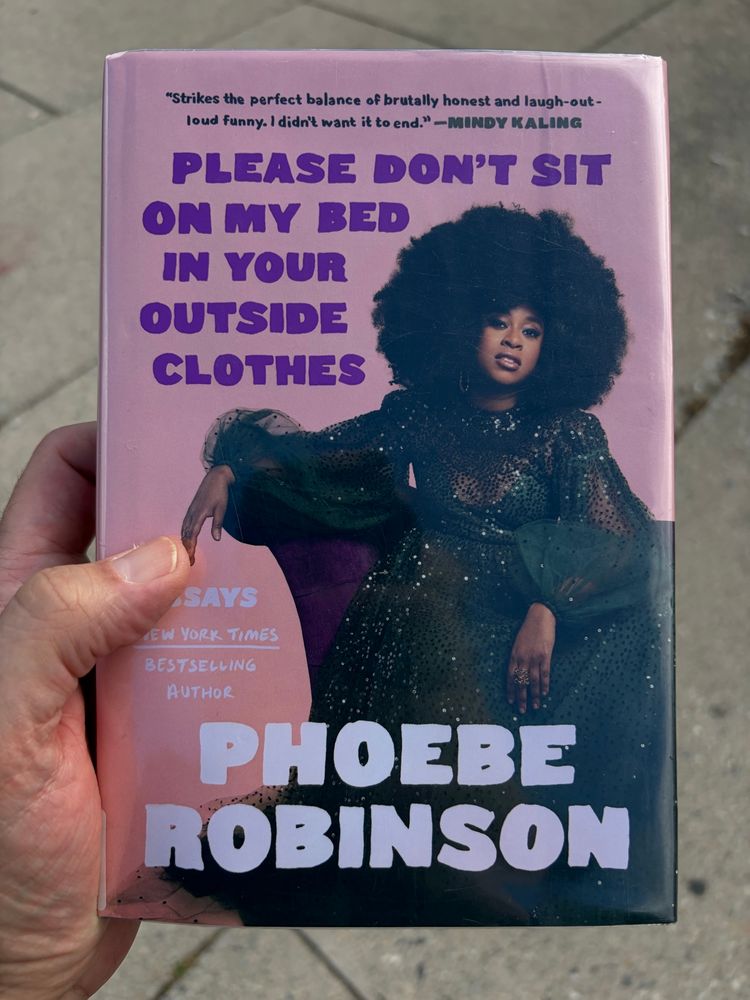 Cover of Phoebe Robinson’s essay collection, Please Don’t Sit On My Bed In Your Outside Clothes, featuring a color photo of the author.
