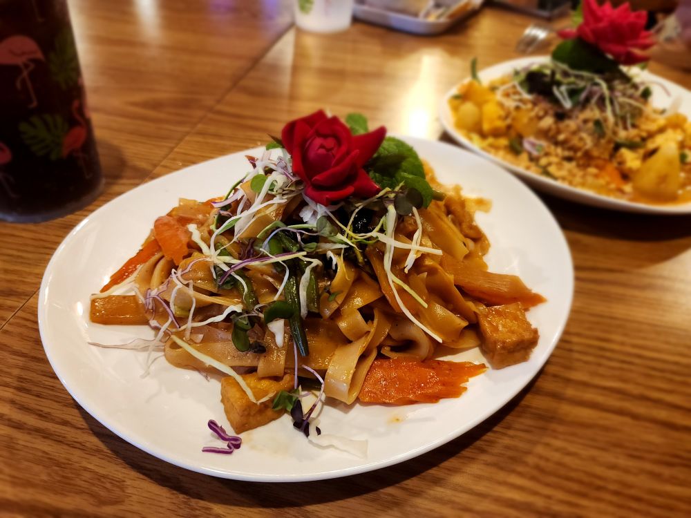 Vegan Drunken Noodles curry dish with a rose on top