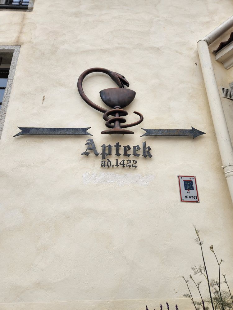 Snake and cup labeled Apteek ad. 1422 (apothecary established 1422)