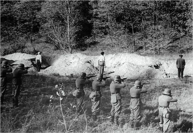 Nazi soldiers execute Ukrainian Jews standing in front of their own mass grave.