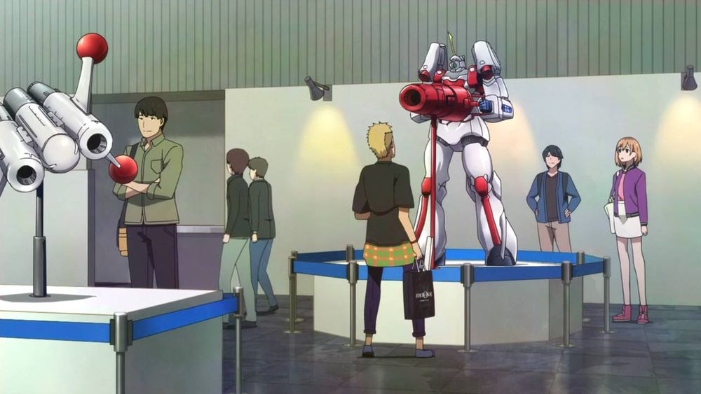 Some people gawking at a human-sized statue of the Idepon robot itself, holding the Idepon Cannon.