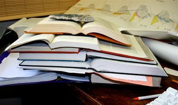 Stack of books with rock on top, photo by Robert Thorson