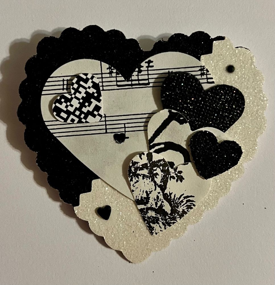 A black and white Valentine heart with music and toile 