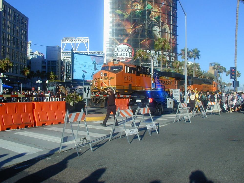 Large cargo train passing through Gaslamp district of San Diego during comic con