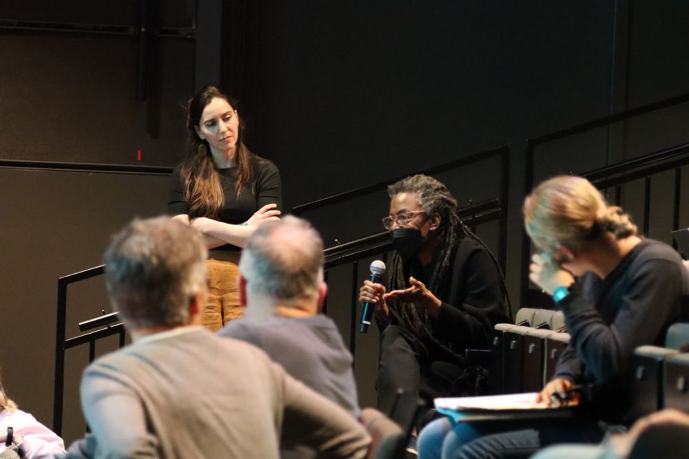Audience member asking question with microphone in hand
