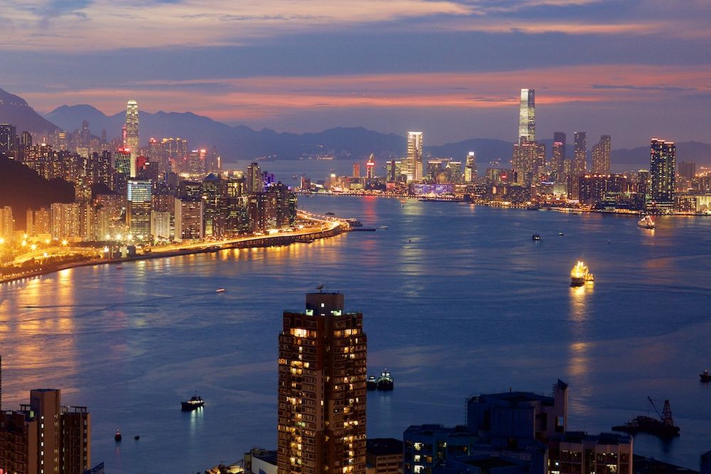 Victoria Harbour and the Hong Kong skyline at dusk. Hong Kong island on the left, Kowloon on the right.
