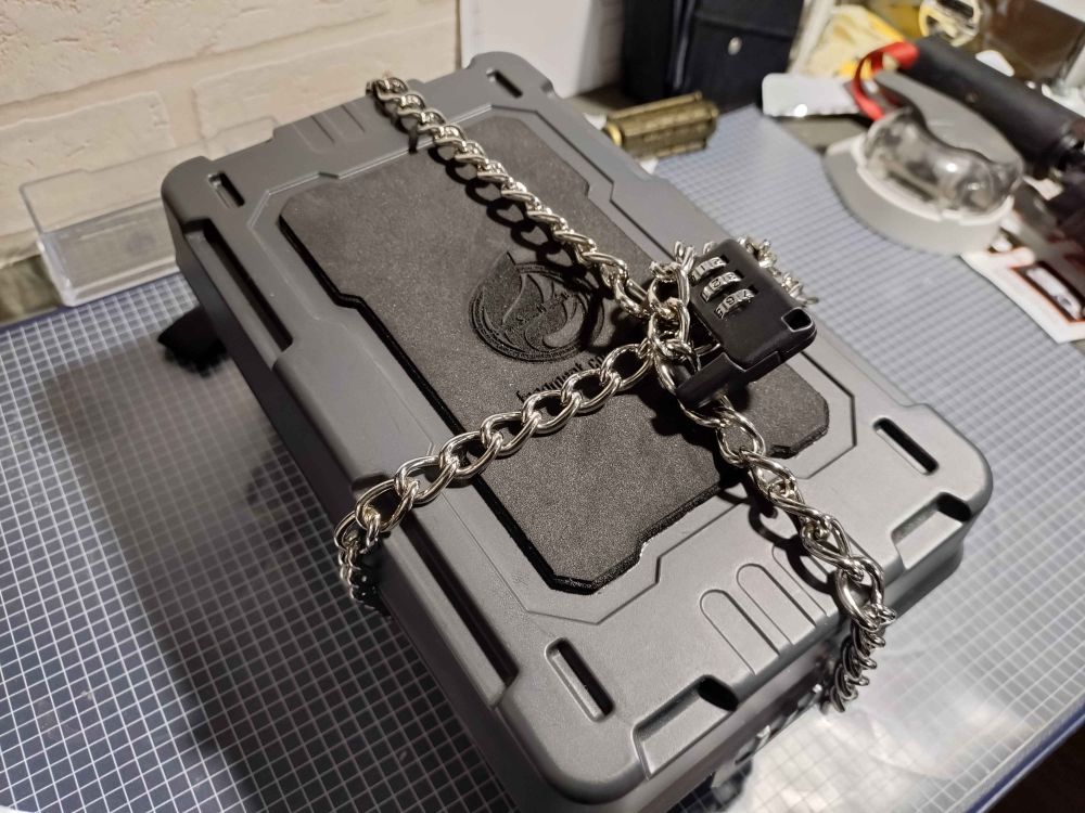 A box, sealed with chains and a combination lock
