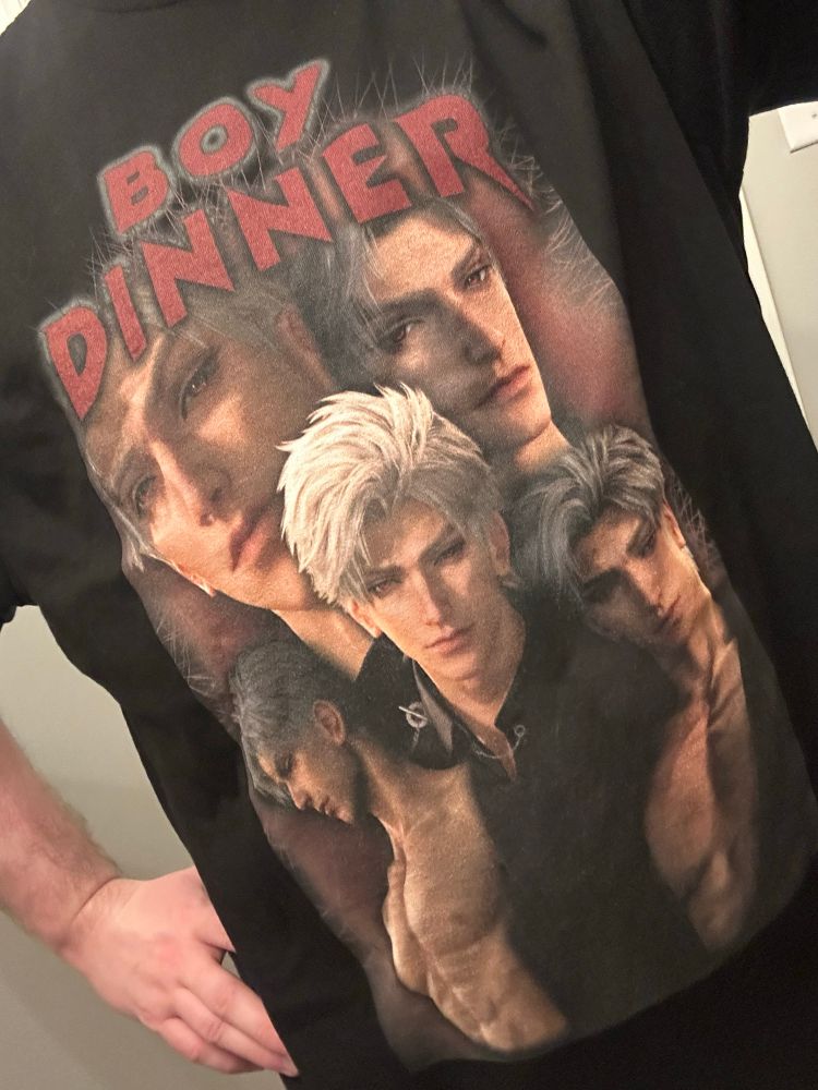 Black tshirt with photos of Sylus’ face from Love and Deepspace with the text “Boy Dinner”