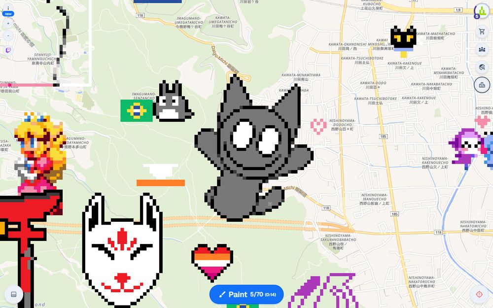 Fuzz the cat with a wide smile and his arms in the air, drawn in WPlace by members of the Sudomemo community.