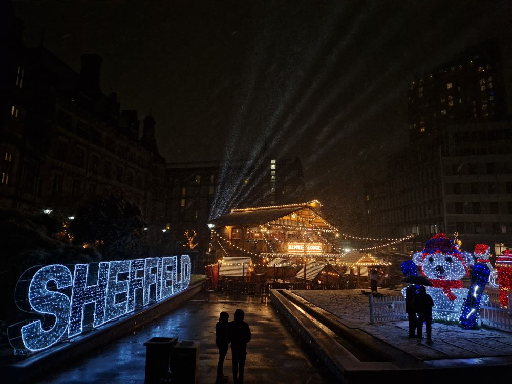 Christmas lights can be seen spelling out Sheffield. An illuminated chalet style building and light up animals can be seen under the snow.
