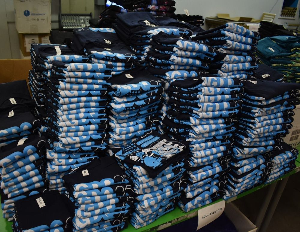 Piles of AGDQ 2025 tees sit on a table