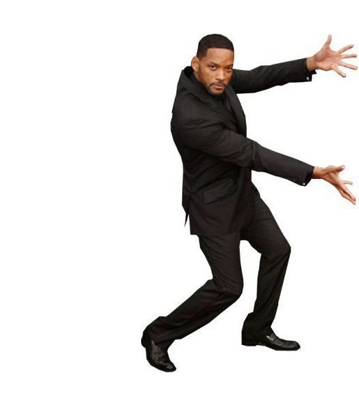Will Smith, dressed in a black suit, gestures presentingly towards the other picture.